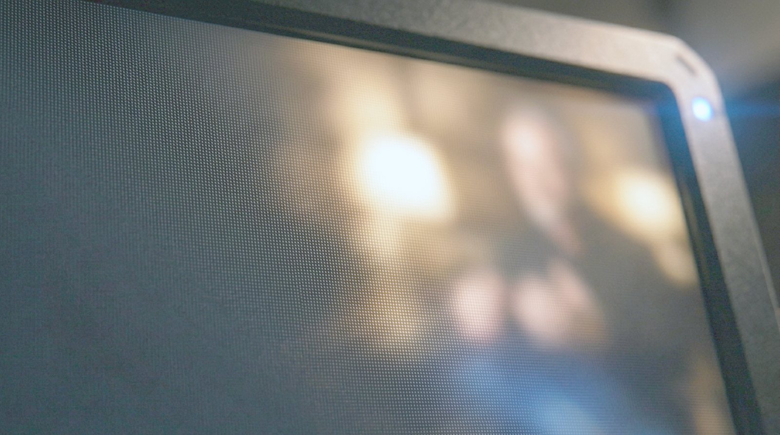 A camera monitor showing a softly focused interview shot
